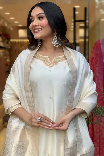 Off white colour viscosee chanderi fabric partywear ready suit with embroidery work