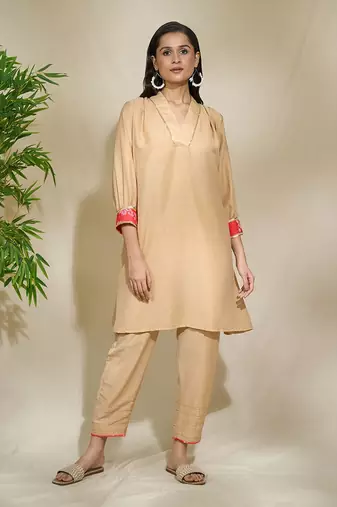Beige red pink tunic set - tagai work highlighted zari sequence work on pants sleeves & back