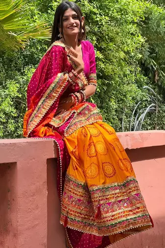 Pink bandhani print silk saree  with lace border and unstitched blouse piece