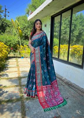 Teal patola silk saree and has a  zari border blouse piece 1