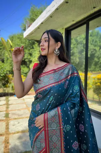 Teal patola silk saree and has a  zari border blouse piece