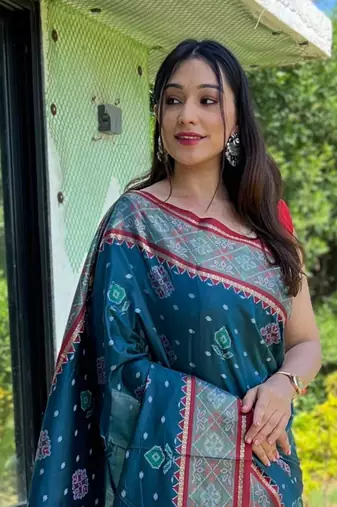 Teal patola silk saree and has a  zari border blouse piece