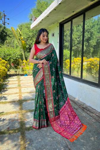 Green patola silk saree and has a  zari border blouse piece