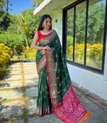 Green patola silk saree and has a  zari border blouse piece