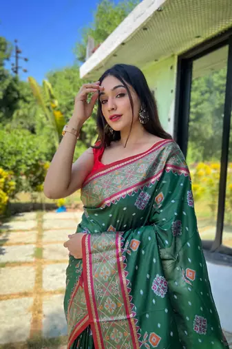 Green patola silk saree and has a  zari border blouse piece