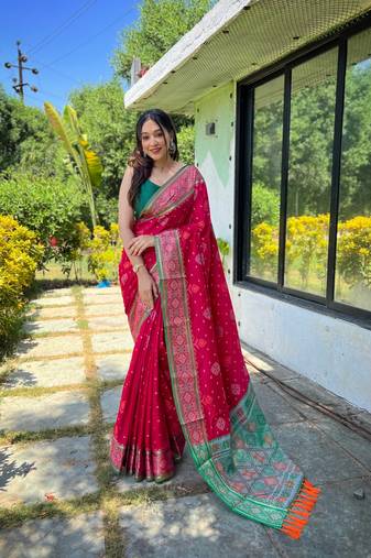 Pink patola silk saree and has a  zari border blouse piece