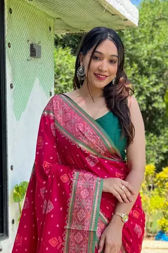 Pink patola silk saree and has a  zari border blouse piece