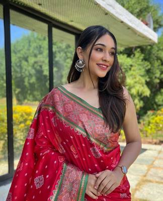 Red patola silk saree and has a  zari border blouse piece 3