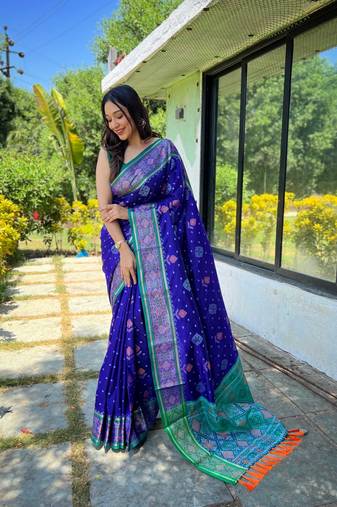 Royal blue patola silk saree and has a  zari border blouse piece