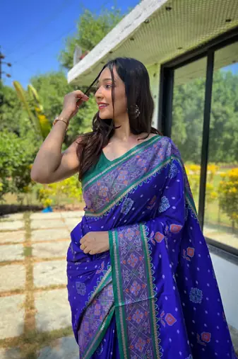 Royal blue patola silk saree and has a  zari border blouse piece