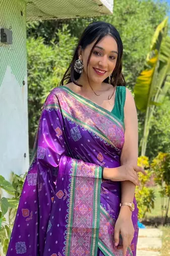 Purple patola silk saree and has a  zari border blouse piece