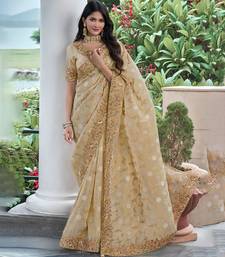 Beige pure tissue silk heavy thread embroidery work on border with zari weaving saree with blouse