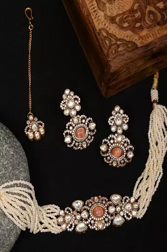Stone and mossainite kundan in pearls with matching earrings and maang tikka