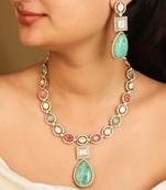 High gold necklace set with emerald green and ruby stones