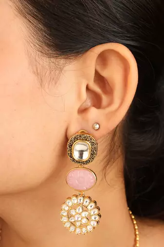 Gold necklace set with stone-studded pendant and matching earrings