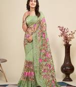 Mint saree with embroidered borders & pink floral patches