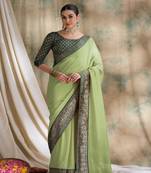 Light green saree with zari woven border & dark green blouse
