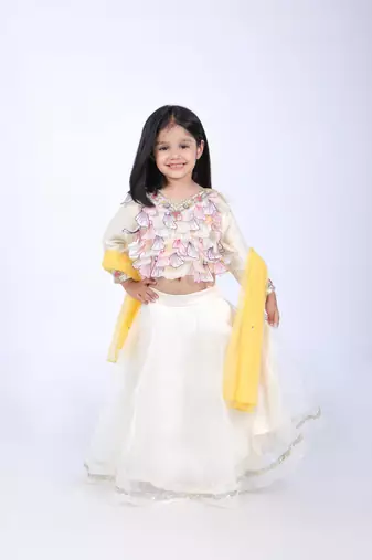 Off white top and organza lehenga with yellow dupatta