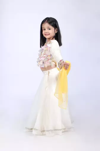 Off white top and organza lehenga with yellow dupatta