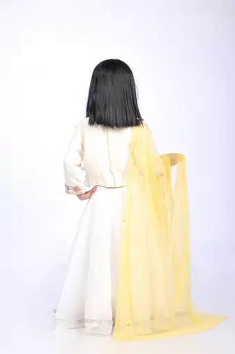 Off white top and organza lehenga with yellow dupatta