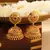 Gold Jhumkas with Pink Stone Accent