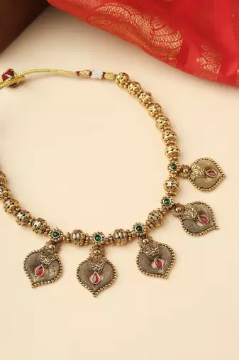 High Gold Necklace with Gold Motifs, Matching Earrings, and Stone Accents