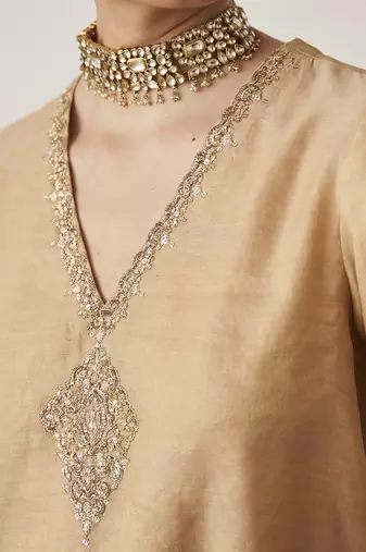 The gold silk tissue chanderi gharara set with pittha handwork