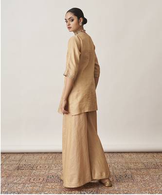 The gold silk tissue chanderi gharara set with pittha handwork 4