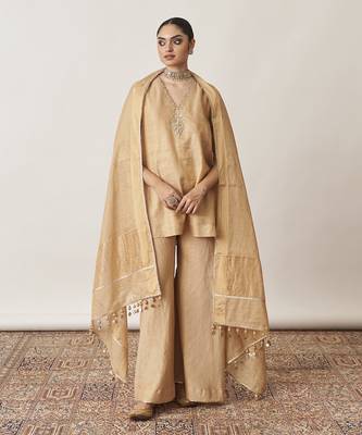 The gold silk tissue chanderi gharara set with pittha handwork 5