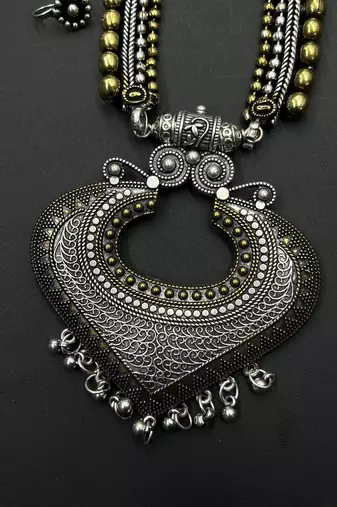 Dual tone long necklace with heart-shaped ghungroo pendant, matching ring, jhumka, bangles & silver nose pin