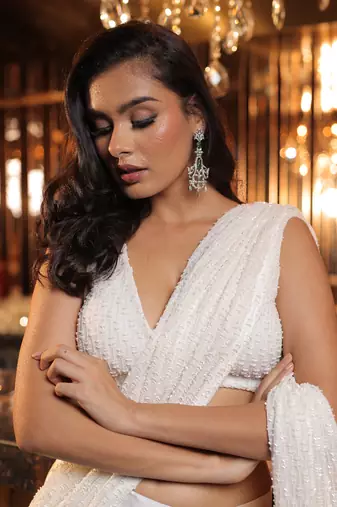 Cream pre draped saree with embellished blouse