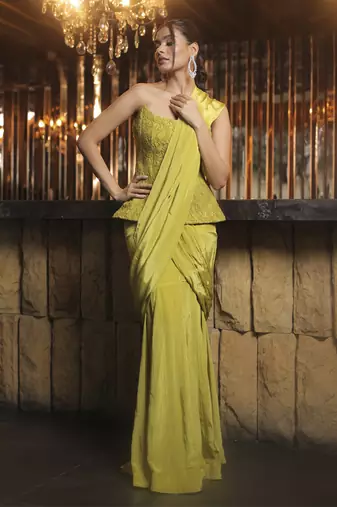 Parrot green pre draped saree with corset blouse in chantley net.