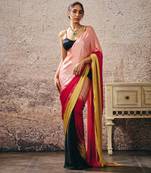 Black blouse with black and red peach gold ombre saree