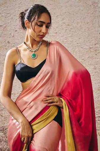 Black blouse with black and red peach gold ombre saree