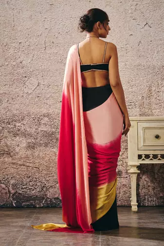 Black blouse with black and red peach gold ombre saree