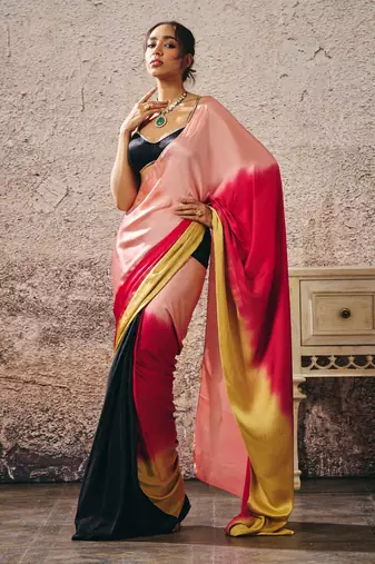 Black blouse with black and red peach gold ombre saree