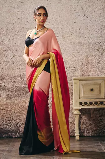 Black blouse with black and red peach gold ombre saree