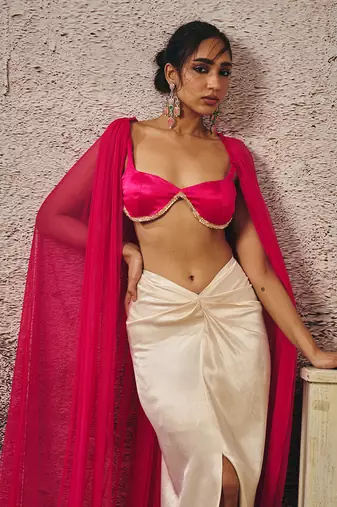 Beige skirt hot pink blouse with hot pink cape