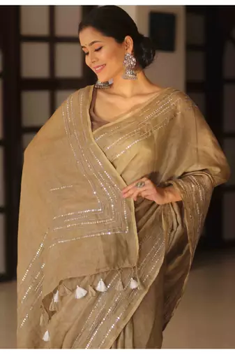Handmade bhagalpuri linen saree with mirror work in beige shade with blouse piece