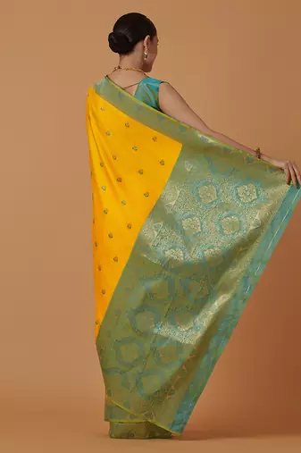 Yellow banarasi silk blend saree with dulha dulhan zari woven detailing