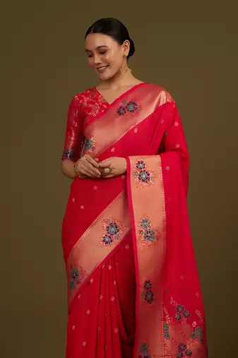 Pink woven silk blend saree with floral motifs zari work