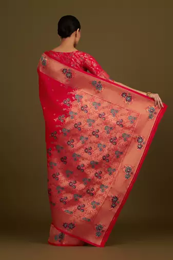 Pink woven silk blend saree with floral motifs zari work