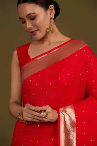 Red woven silk blend saree with floral motifs zari work