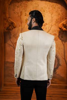 Cream suede suit with floral engraving and hand embroidery highlights 4