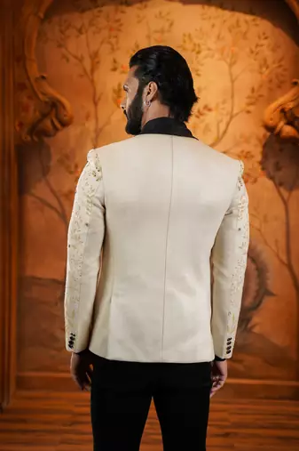 Cream suede suit with floral engraving and hand embroidery highlights