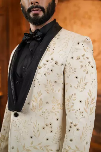 Cream suede suit with floral engraving and hand embroidery highlights