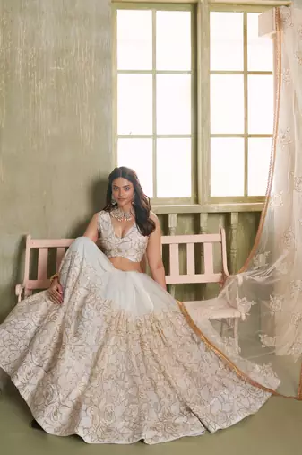 OFF WHITE NET FABRIC LAHENGA CHOLI WITH SEQUINS AND THREAD EMBROIDERY WORK