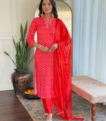 Orange muslin printed with thread embroidery work on neck kurta pant set