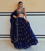 DEEP NECKLINE EMBROIDERED SLEEVELESS BLOUSE WITH FLORAL BUTTI EMBROIDERED LEHENGA AND DUPATTA