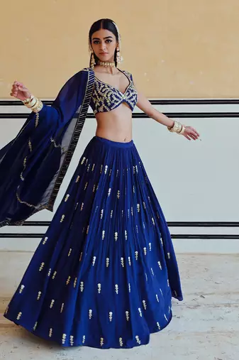 DEEP NECKLINE EMBROIDERED SLEEVELESS BLOUSE WITH FLORAL BUTTI EMBROIDERED LEHENGA AND DUPATTA
